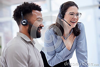 Cheerful caucasian call centre telemarketing agent training new mixed race assistant on in an office. happy supervisor Stock Photo