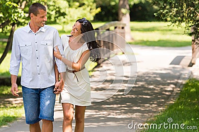 Cheerful Caucasian couple walking outdoors Stock Photo