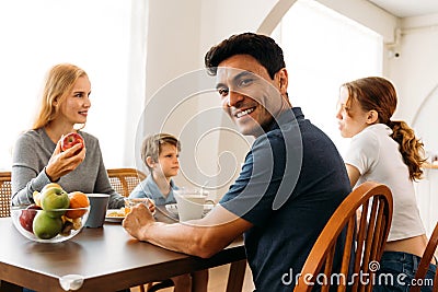 Happy family talking while enjoying breakfast Stock Photo