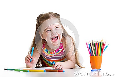 Cheerful child girl drawing with pencils in Stock Photo
