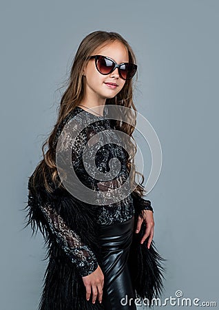 cheerful child in glasses with curly hairdo, beauty Stock Photo