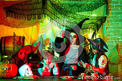 Cheerful children playing with sweets and candy. Group kids like zombie or witch Ready for Trick or Treat. Witch Stock Photo