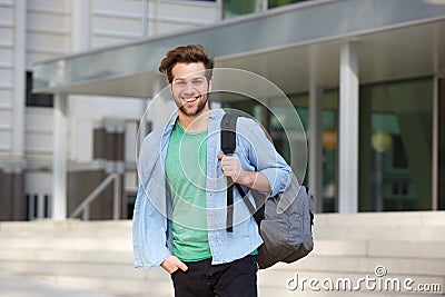 Cheerful college student standing outside with back Stock Photo