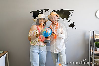 Cheerful couple choosing a summer trip Stock Photo