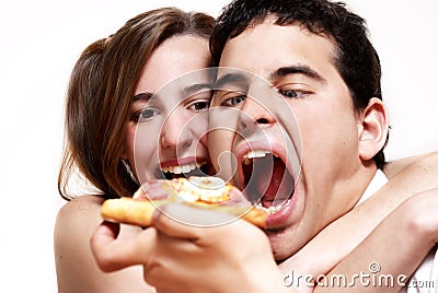 The cheerful couple eating a pizza Stock Photo