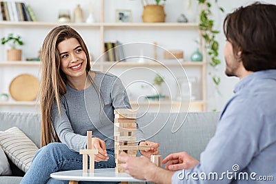 Cheerful couple in love playing Jenga at home Stock Photo