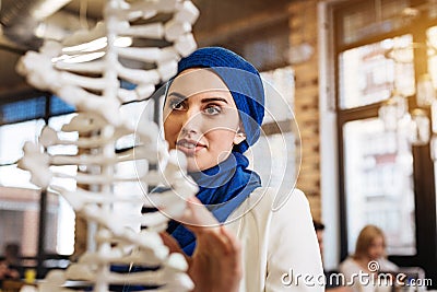 Cheerful curious muslim woman studying genomics Stock Photo