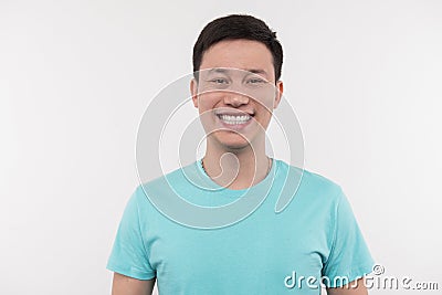 Cheerful delighted man smiling to you Stock Photo