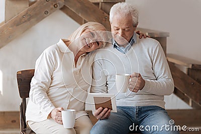 Cheerful delighted woman hugging her husband Stock Photo
