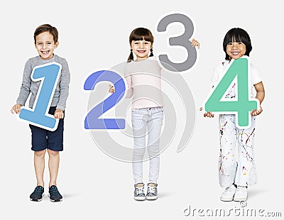 Cheerful diverse kids holding numbers one to four Stock Photo