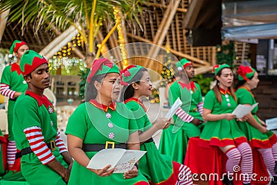 Cheerful diversity male and female group of christmas elves singing song during celebration party Editorial Stock Photo