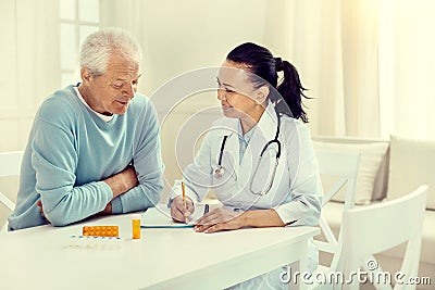 Cheerful doctor and retired gentleman discussing regimen Stock Photo