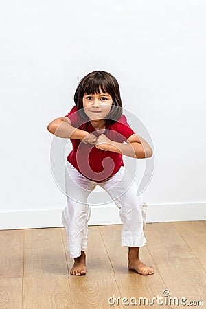 Cheerful energetic young child expressing dynamic body language and motivation Stock Photo
