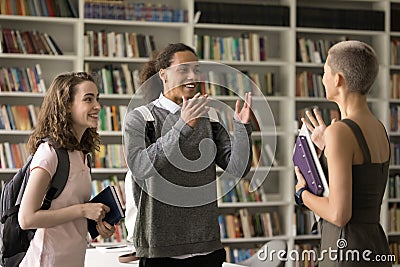 Cheerful excited diverse student girls and guy meeting in college Stock Photo