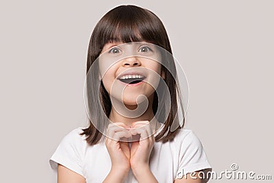 Cheerful excited little girl showing heart love gesture. Stock Photo