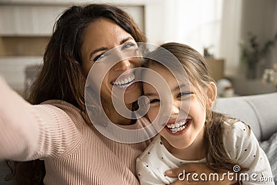 Cheerful excited mom and little kid taking selfie at home Stock Photo