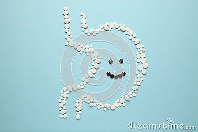 Cheerful face in stomach of pills. Healthy lifestyle, good digestion Stock Photo