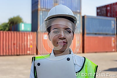 Cheerful factory worker woman in hard hat smiling and looking at camera, Happiness Female engineers for concept Stock Photo