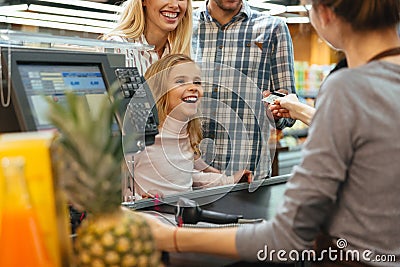 Cheerful family paying with a credit card Stock Photo