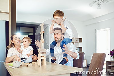 A family plays board games sitting at a table indoors. Stock Photo