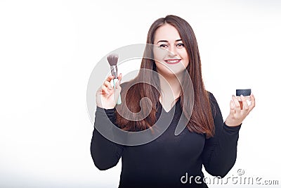 Cheerful fat brunette has fun posing with cosmetic. Plus size model, wear bodysuit in the studio with big boobs Stock Photo
