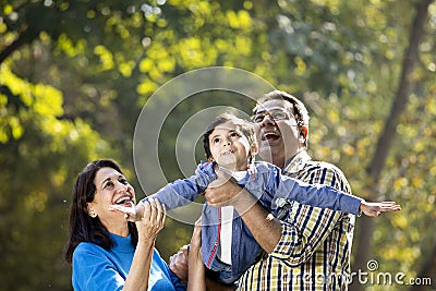 Cheerful father lifting daughter and helping her fly Stock Photo