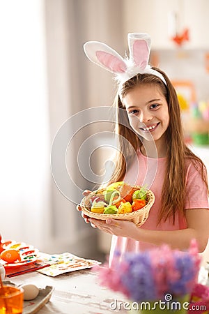 Child hold basket with colorful easter eggs Stock Photo