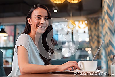 Cheerful female freelancer performing project Stock Photo