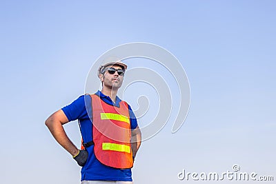 Cheerful female shipping company workers working at the harbor, Engineering man looking to the sky Stock Photo