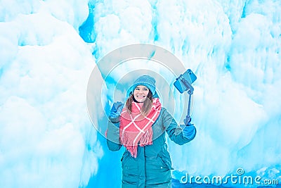 Cheerful female wonderer waves hand and talking via smartphone during video call Stock Photo