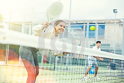 Young girl paddle tennis player performing forehand Stock Photo