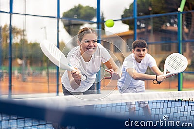 Young girl paddle tennis player performing forehand Stock Photo