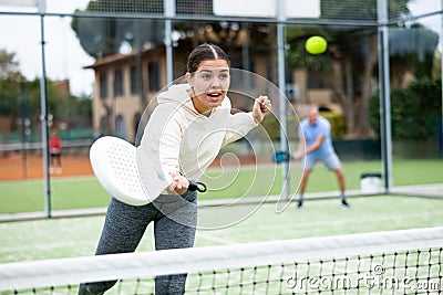 Young girl paddle tennis player performing forehand Stock Photo