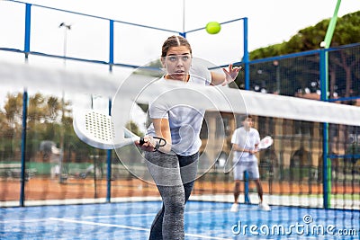 Young girl paddle tennis player performing forehand Stock Photo