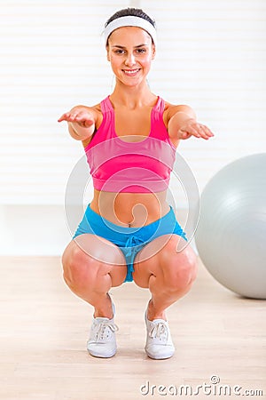 Cheerful fitness young girl doing exercises Stock Photo