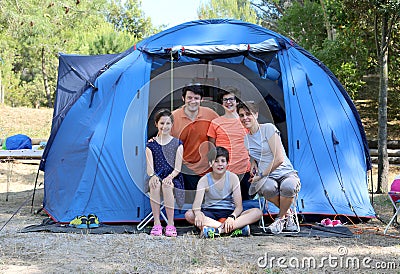 Cheerful five-person family with three children with camping ten Stock Photo