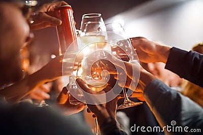 Cheerful friends clinking glasses above dinner table. Alcohol and toasting, party and celebration theme. Congratulations Stock Photo