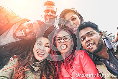 Cheerful friends from different countries and races taking selfie with back lighting - Happy youth concept with young people Stock Photo