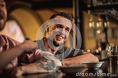 Cheerful friends drinking draft beer in a pub Stock Photo