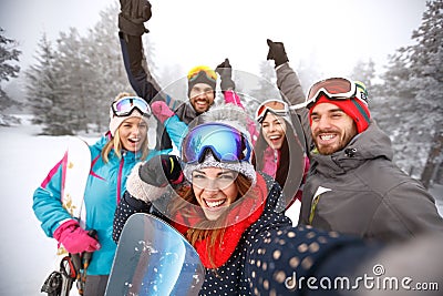 Friends with hands up on skiing Stock Photo