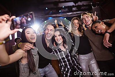 Cheerful friends taking selfie while enjoying at nightclub Stock Photo