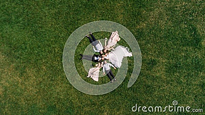 Cheerful and fun groom with bride, bridesmaids and groomsmen pos Stock Photo