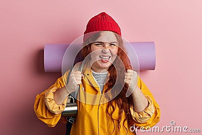 Cheerful funny crazy backpacker woman celebrating successful holiday, travel Stock Photo