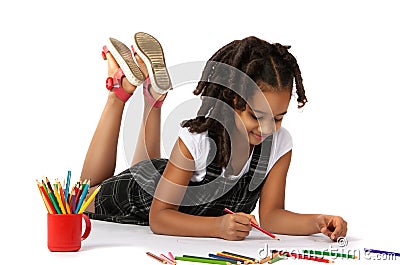 Cheerful girl draws pencil lying on the floor Stock Photo