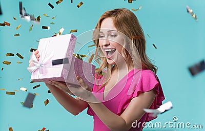 Cheerful girl opening gift box with interest Stock Photo