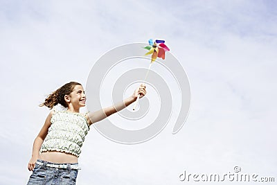 Cheerful Girl Playing With Pinwheel Stock Photo