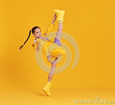 Cheerful girl in raincoat and gumboots Stock Photo