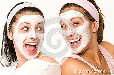 Cheerful girls having facial mask and laughing Stock Photo