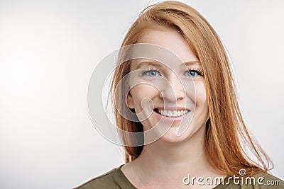 A cheerful gorgeous ginger woman wearing her hair loose Stock Photo