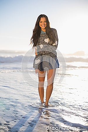 Cheerful gorgeous woman barefoot in the sea Stock Photo